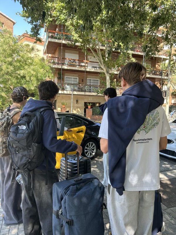 Νέοι με σακίδια και βαλίτσες σε δρόμο της πόλης, έτοιμοι να φύγουν.